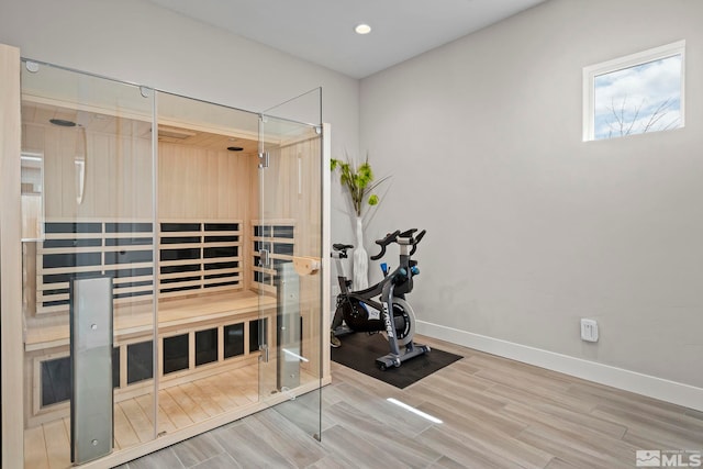 sauna / steam room featuring wood finished floors, baseboards, and recessed lighting