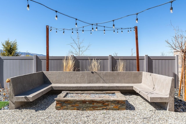 view of patio / terrace featuring a fire pit and a fenced backyard