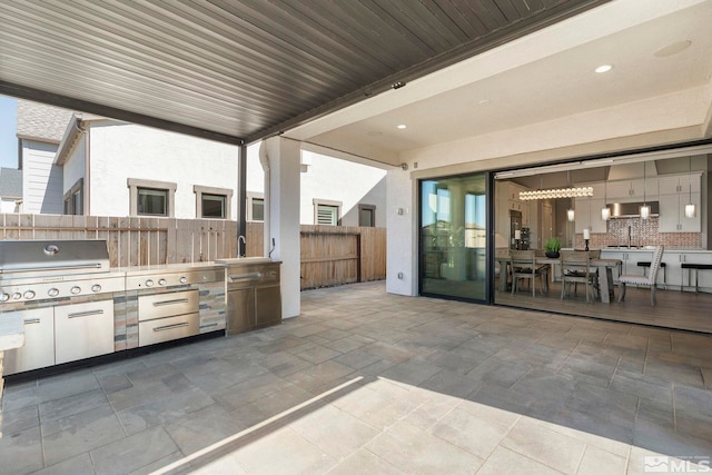 view of patio with fence and area for grilling