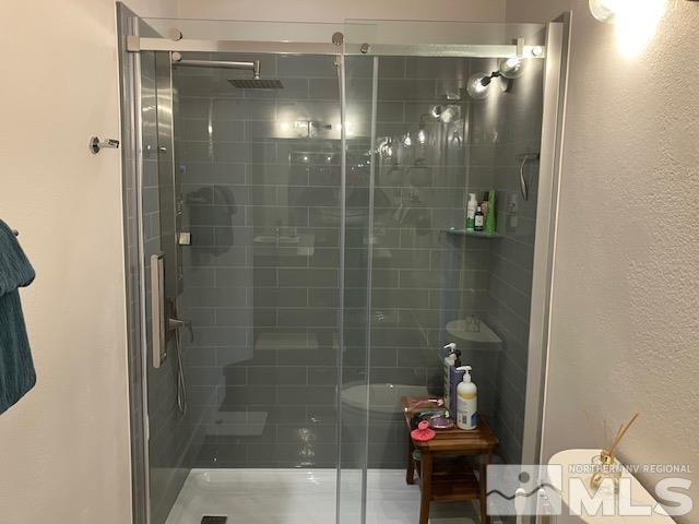 bathroom with a shower stall