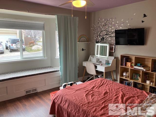 bedroom with wood finished floors and ceiling fan