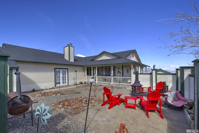 1875 View Ct, Fernley, NV 89408 - back of house with a fire pit, a chimney, a porch, french doors, and fence