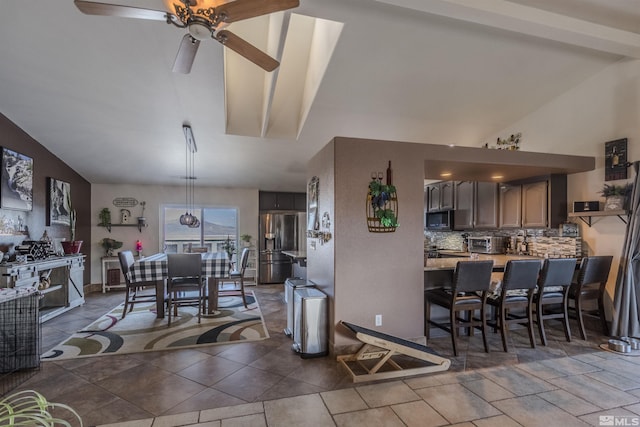 1875 View Ct, Fernley, NV 89408 - kitchen with lofted ceiling, stainless steel refrigerator with ice dispenser, ceiling fan, light countertops, and backsplash