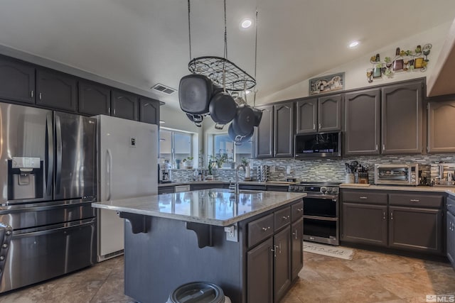 1875 View Ct, Fernley, NV 89408 - kitchen with stainless steel appliances, decorative backsplash, lofted ceiling, a breakfast bar area, and a sink