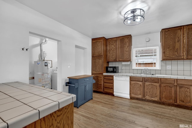 435 14th St, Sparks, NV 89431 - kitchen featuring dishwasher, gas water heater, a sink, black microwave, and decorative backsplash