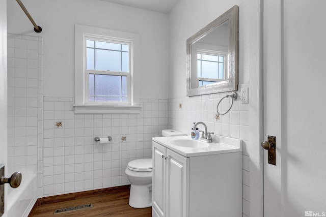 435 14th St, Sparks, NV 89431 - bathroom featuring tile walls, toilet, vanity, wainscoting, and wood finished floors