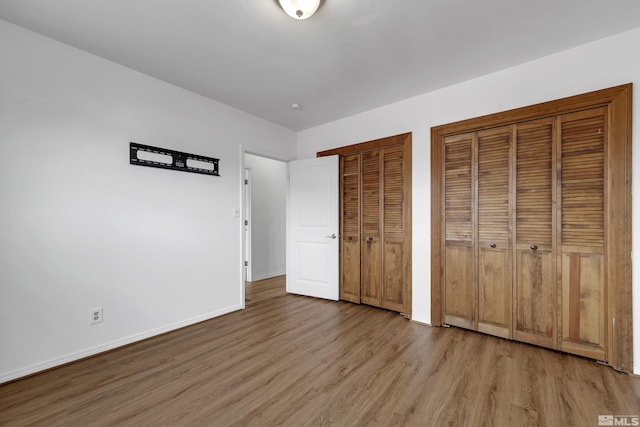 435 14th St, Sparks, NV 89431 - unfurnished bedroom with multiple closets, wood finished floors, and baseboards
