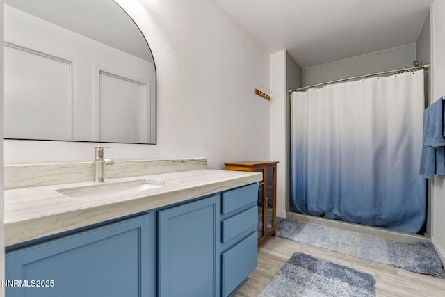 7721 Welsh Dr, Reno, NV 89506 - bathroom featuring vanity, wood finished floors, and a shower with shower curtain