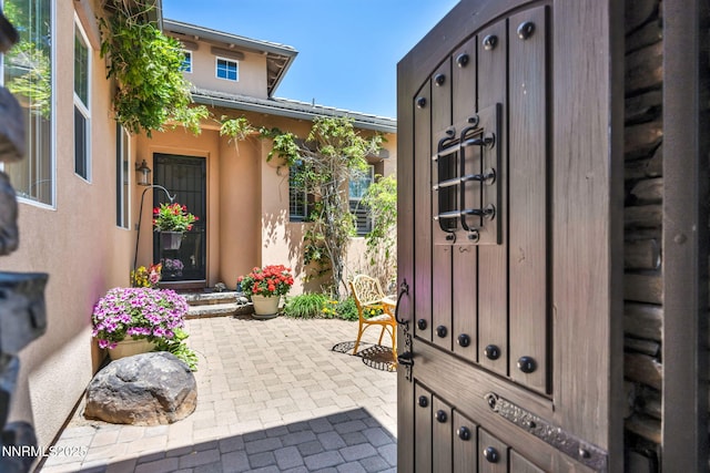 10100 Via Ponte, Reno, NV 89511 - doorway to property with a patio area and stucco siding