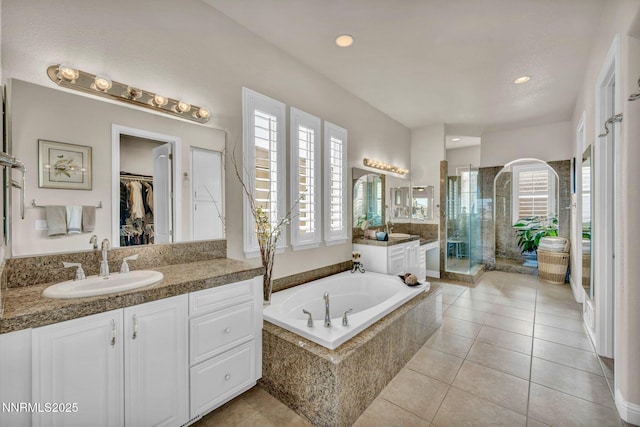 10100 Via Ponte, Reno, NV 89511 - full bath featuring vanity, a shower stall, a garden tub, tile patterned flooring, and recessed lighting