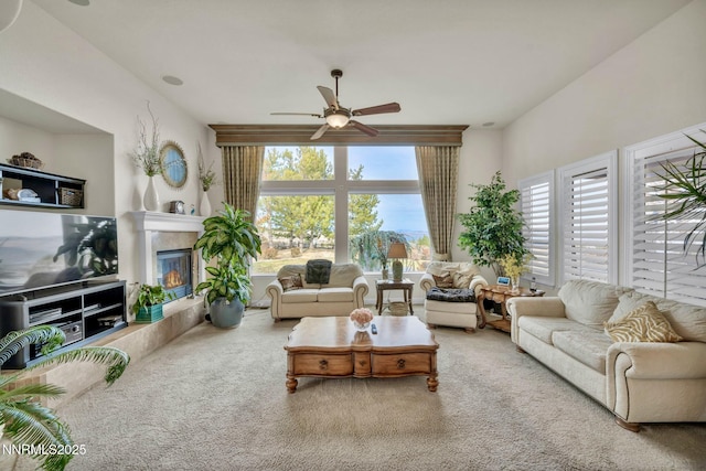 10100 Via Ponte, Reno, NV 89511 - living area featuring a ceiling fan, carpet floors, and a tiled fireplace