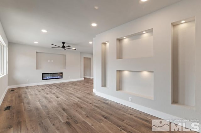 995 Skyline Blvd, Reno, NV 89509 - unfurnished living room featuring ceiling fan, wood finished floors, recessed lighting, baseboards, and a glass covered fireplace
