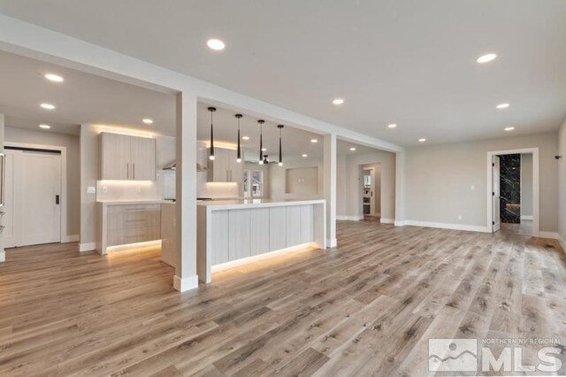 995 Skyline Blvd, Reno, NV 89509 - unfurnished living room with recessed lighting, light wood finished floors, and baseboards