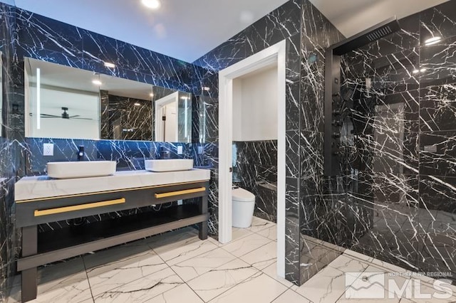 995 Skyline Blvd, Reno, NV 89509 - bathroom featuring tile walls, stone wall, marble tiled floors, toilet, and vanity