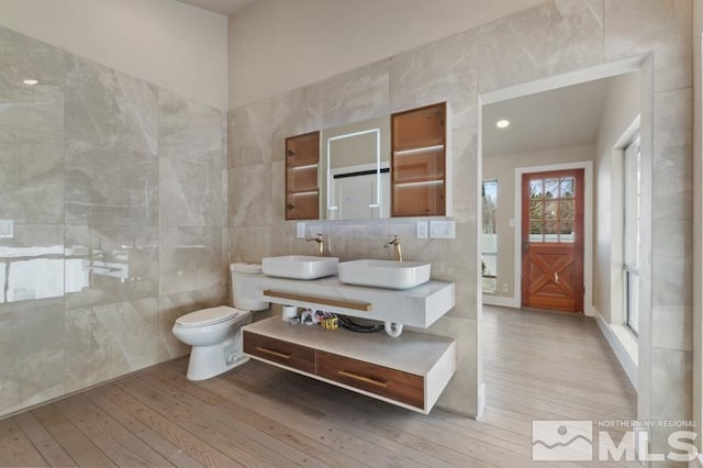 995 Skyline Blvd, Reno, NV 89509 - full bathroom featuring tile walls, wood-type flooring, toilet, and double vanity