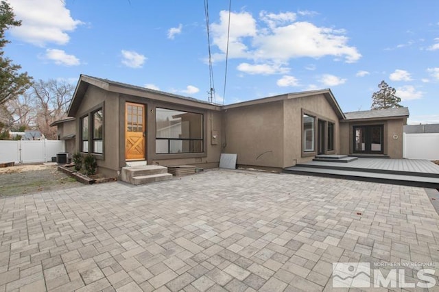 995 Skyline Blvd, Reno, NV 89509 - back of property with fence, a deck, a patio, and central AC unit