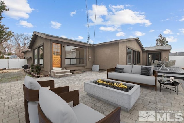 995 Skyline Blvd, Reno, NV 89509 - rear view of house with an outdoor living space with a fire pit, stucco siding, central AC, and a patio