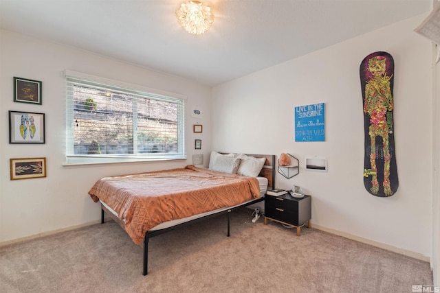 bedroom with light carpet and baseboards
