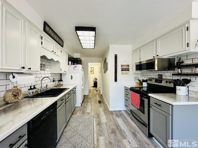 3940 Pheasant, Carson City, NV 89701 - kitchen with appliances with stainless steel finishes, gray cabinets, a sink, backsplash, and light countertops