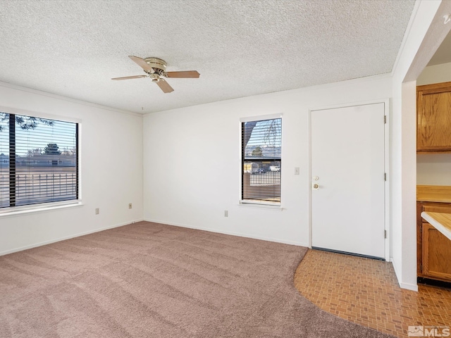 1465 E Peckham Ln Apt 55, Reno, NV 89502 - spare room with a ceiling fan, light carpet, a textured ceiling, and baseboards