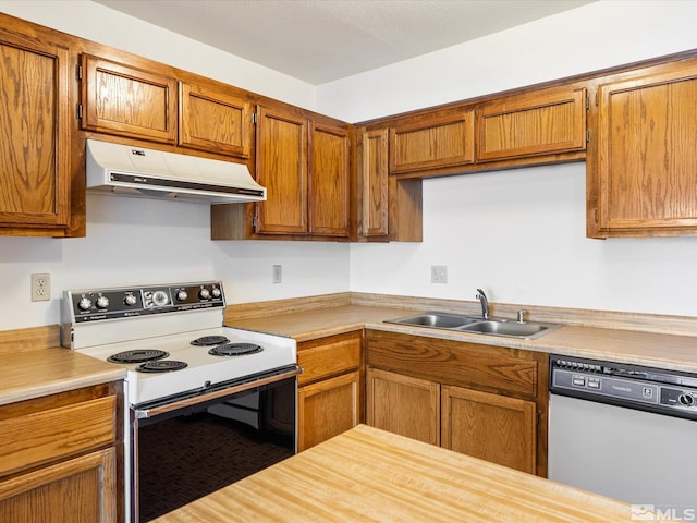 1465 E Peckham Ln Apt 55, Reno, NV 89502 - kitchen with white appliances, range hood, a sink, and light countertops