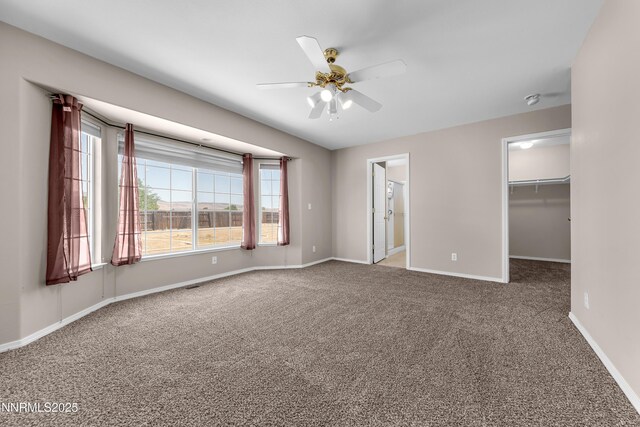 2172 Redhead Dr, Sparks, NV 89441 - unfurnished bedroom with carpet floors, a walk in closet, baseboards, and a ceiling fan