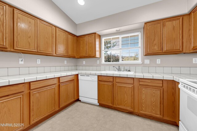 2172 Redhead Dr, Sparks, NV 89441 - kitchen with white appliances, a sink, brown cabinets, and light countertops