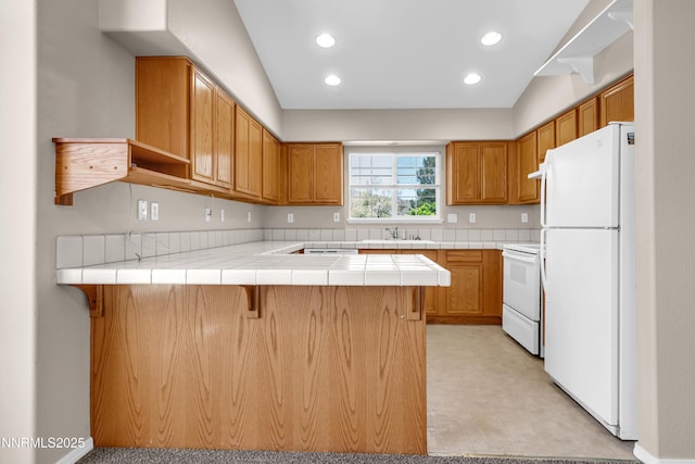 2172 Redhead Dr, Sparks, NV 89441 - kitchen featuring freestanding refrigerator, stove, a peninsula, a sink, and light floors