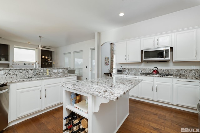 1659 Chiquita Ci, Minden, NV 89423 - kitchen featuring appliances with stainless steel finishes, a sink, open shelves, white cabinetry, and dark wood-style flooring