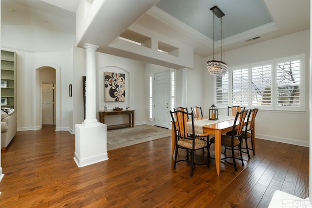 1659 Chiquita Ci, Minden, NV 89423 - dining area featuring arched walkways, ornate columns, dark wood finished floors, ornamental molding, and baseboards