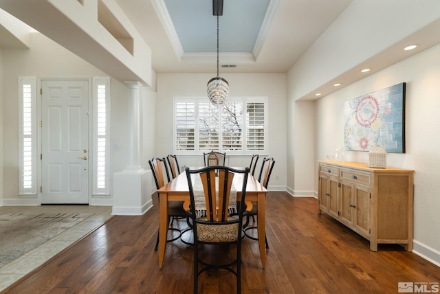 1659 Chiquita Ci, Minden, NV 89423 - dining room with dark wood-style floors, a chandelier, a tray ceiling, decorative columns, and baseboards