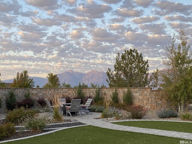 1659 Chiquita Ci, Minden, NV 89423 - yard at dusk featuring a patio and a mountain view