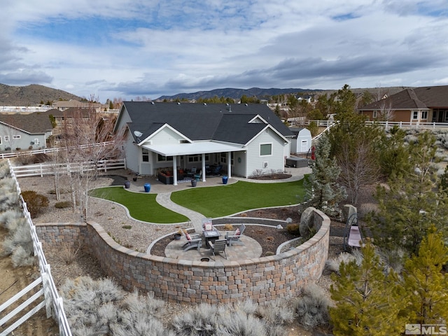 1659 Chiquita Ci, Minden, NV 89423 - back of house with a patio area, an outdoor fire pit, and a mountain view