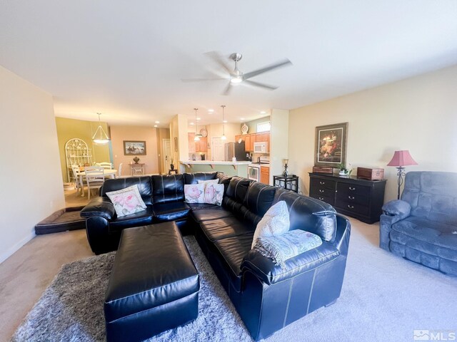 1090 Aster Ln, Fernley, NV 89408 - living area with light carpet, ceiling fan, and baseboards