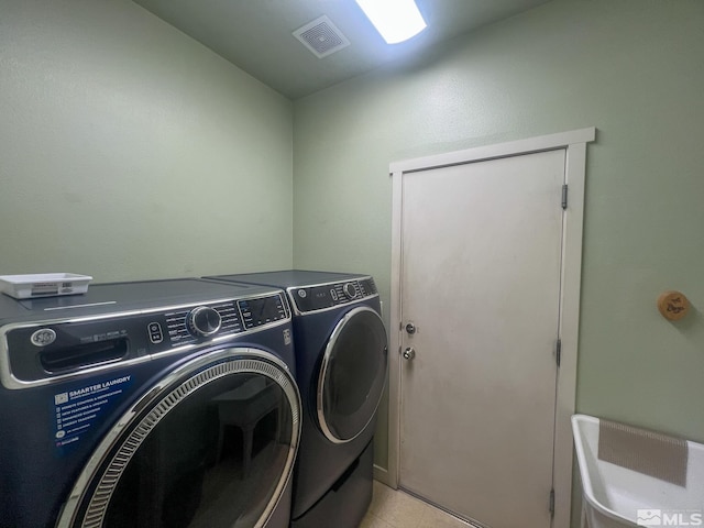 1090 Aster Ln, Fernley, NV 89408 - laundry area featuring washing machine and dryer and light tile patterned flooring