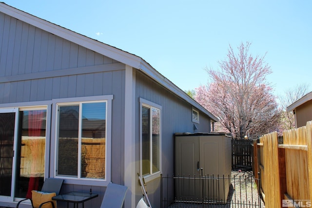 1090 Aster Ln, Fernley, NV 89408 - view of property exterior with fence, a storage shed, and an outdoor structure