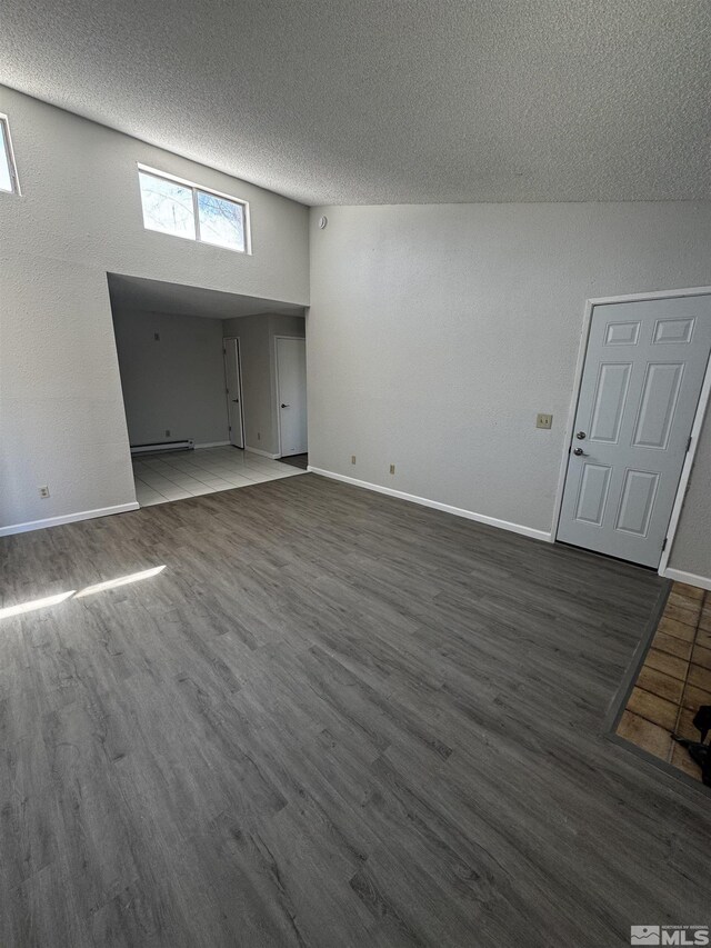 2375 Tripp Dr Unit 6, Reno, NV 89512 - unfurnished living room with wood finished floors, baseboards, a textured ceiling, and a baseboard radiator
