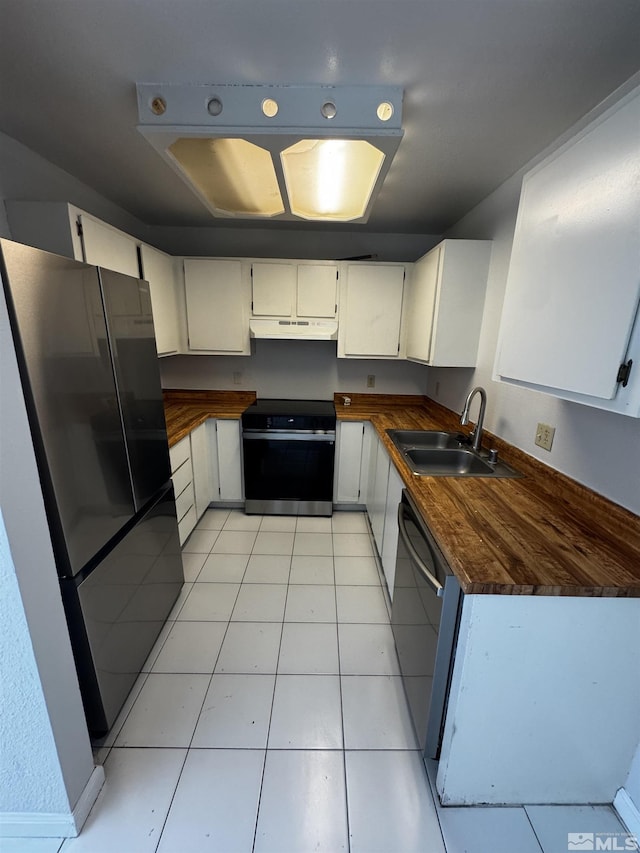 2375 Tripp Dr Unit 6, Reno, NV 89512 - kitchen with appliances with stainless steel finishes, a sink, under cabinet range hood, dark countertops, and light tile patterned floors