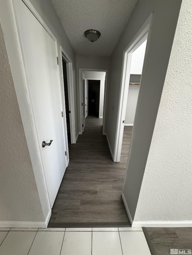 2375 Tripp Dr Unit 6, Reno, NV 89512 - corridor with a textured ceiling, baseboards, wood finished floors, and a textured wall