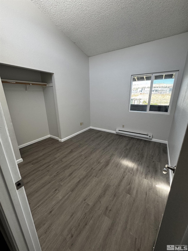 2375 Tripp Dr Unit 6, Reno, NV 89512 - unfurnished bedroom featuring a baseboard heating unit, dark wood-type flooring, a textured ceiling, baseboards, and a closet