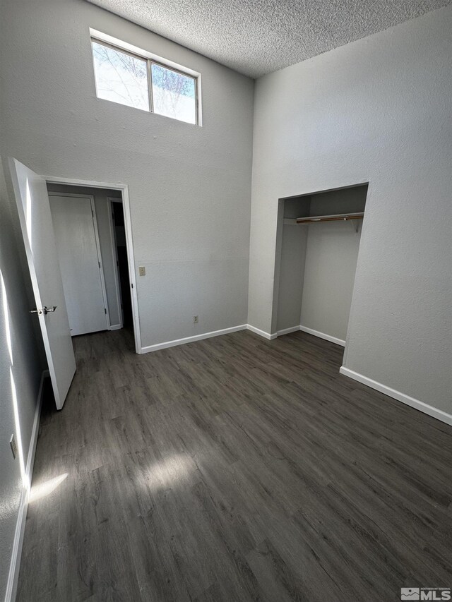 2375 Tripp Dr Unit 6, Reno, NV 89512 - unfurnished bedroom featuring dark wood finished floors, baseboards, a textured ceiling, and a closet