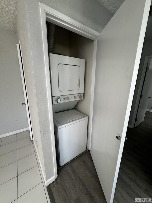 2375 Tripp Dr Unit 6, Reno, NV 89512 - laundry area featuring estacked washer and dryer, wood finished floors, a textured ceiling, and baseboards