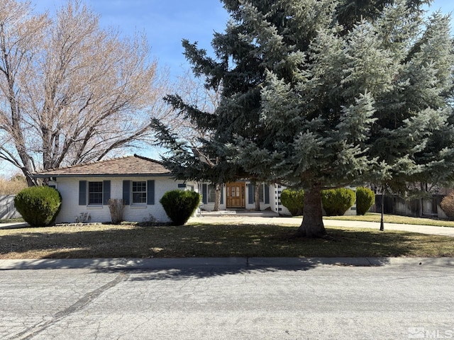 3 Comstock Cir, Carson City, NV 89703 - view of front of home with brick siding and a front yard