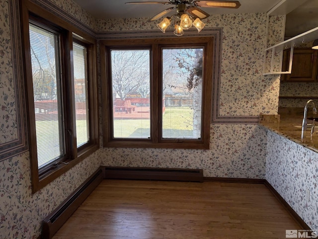 3 Comstock Cir, Carson City, NV 89703 - unfurnished dining area featuring wallpapered walls, healthy amount of natural light, wood finished floors, and a baseboard heating unit