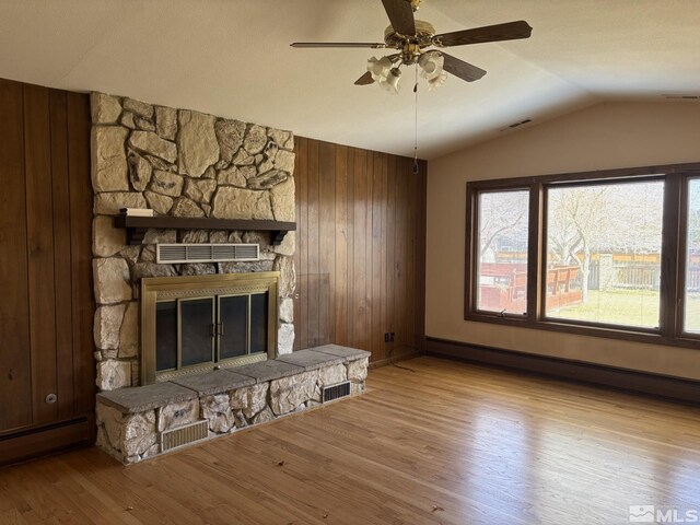 3 Comstock Cir, Carson City, NV 89703 - unfurnished living room featuring vaulted ceiling, baseboard heating, plenty of natural light, wood finished floors, and a ceiling fan