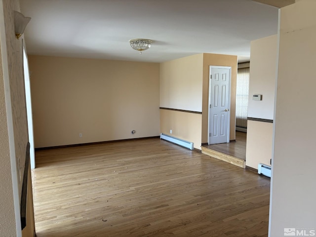 3 Comstock Cir, Carson City, NV 89703 - empty room with a baseboard heating unit, wood finished floors, and baseboards