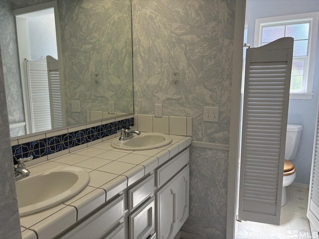 3 Comstock Cir, Carson City, NV 89703 - full bath featuring toilet, double vanity, tile patterned floors, and wallpapered walls