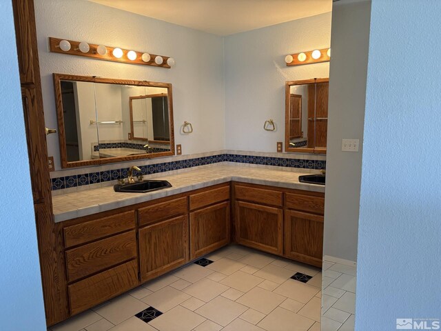 3 Comstock Cir, Carson City, NV 89703 - full bath with tile patterned flooring, double vanity, a textured wall, and decorative backsplash
