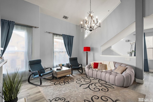 17000 Wedge Pkwy Unit 3221, Reno, NV 89511 - living room featuring wood finished floors, healthy amount of natural light, a chandelier, baseboards, and a towering ceiling
