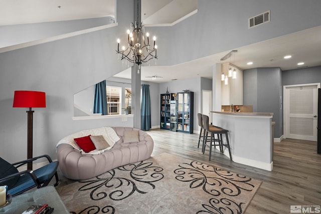 17000 Wedge Pkwy Unit 3221, Reno, NV 89511 - living area with wood finished floors, a chandelier, a high ceiling, and baseboards